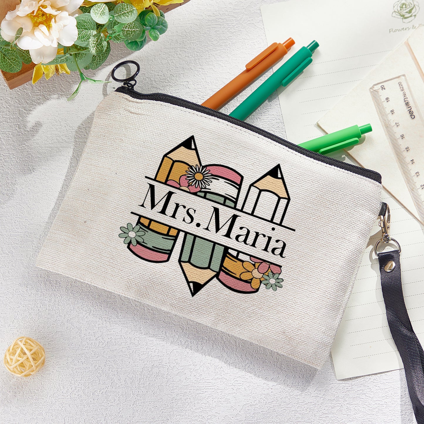 Custom canvas makeup bag with flower pencil design and name, ideal teacher gift.