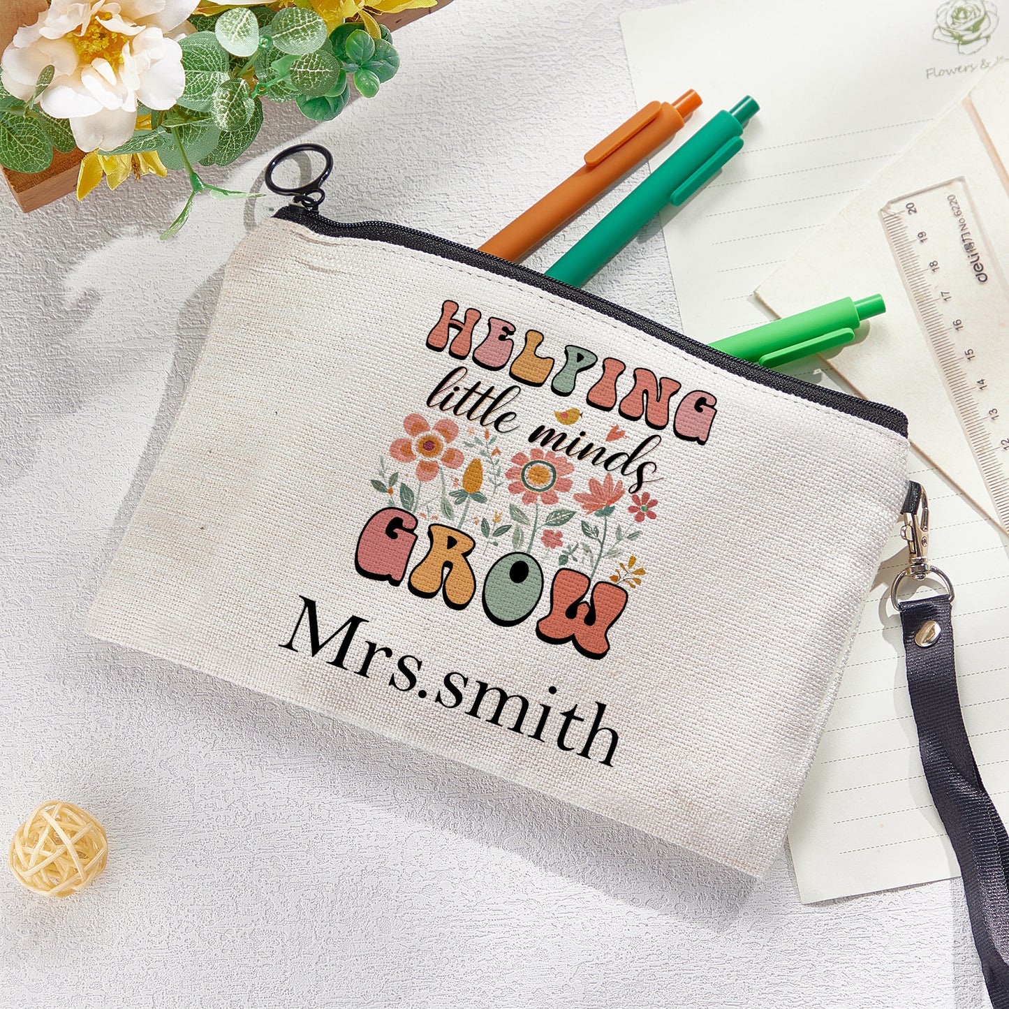 Custom canvas makeup bag with flower pencil design and name, ideal teacher gift.