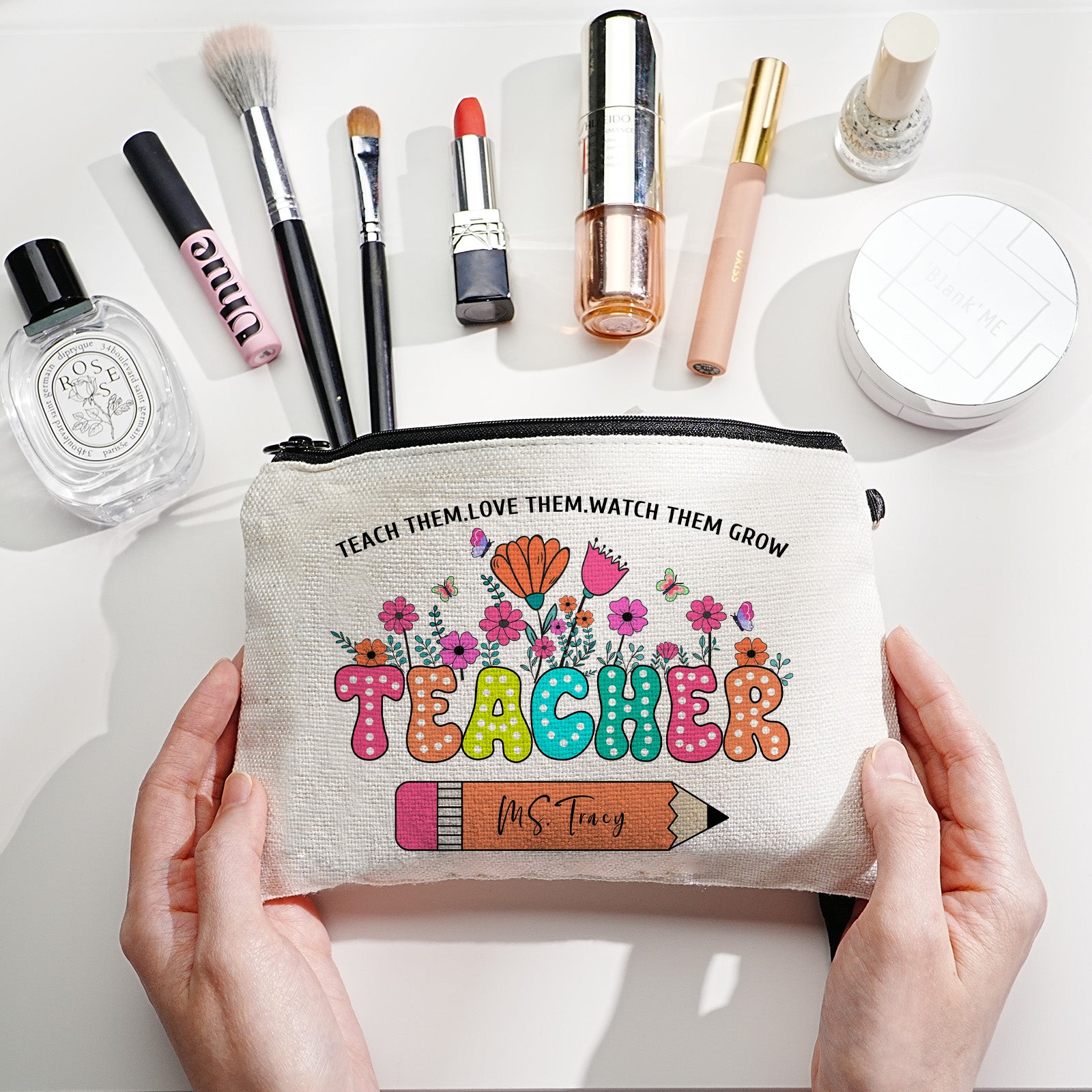 Custom canvas makeup bag with flower pencil design and name, ideal teacher gift.