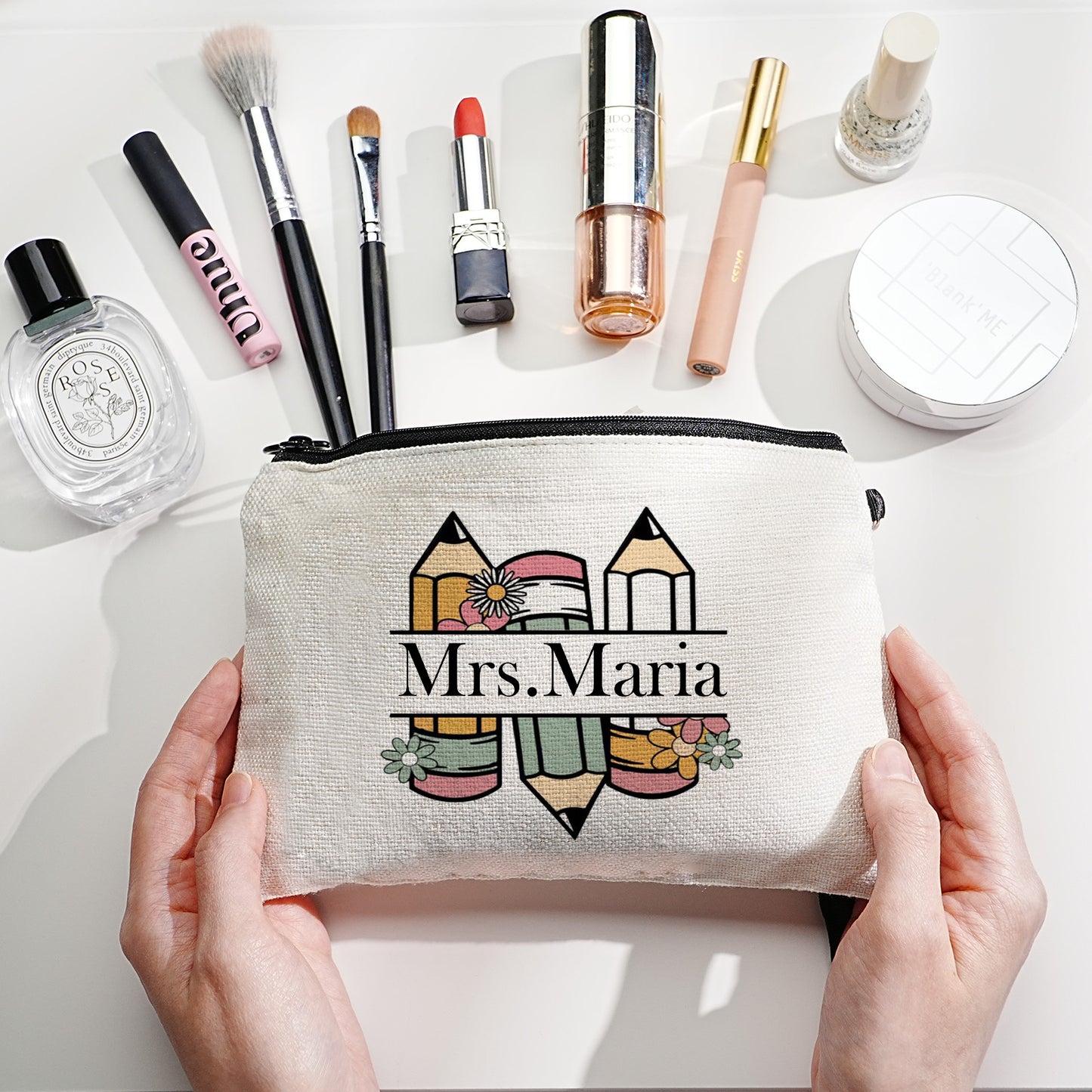 Custom canvas makeup bag with flower pencil design and name, ideal teacher gift.