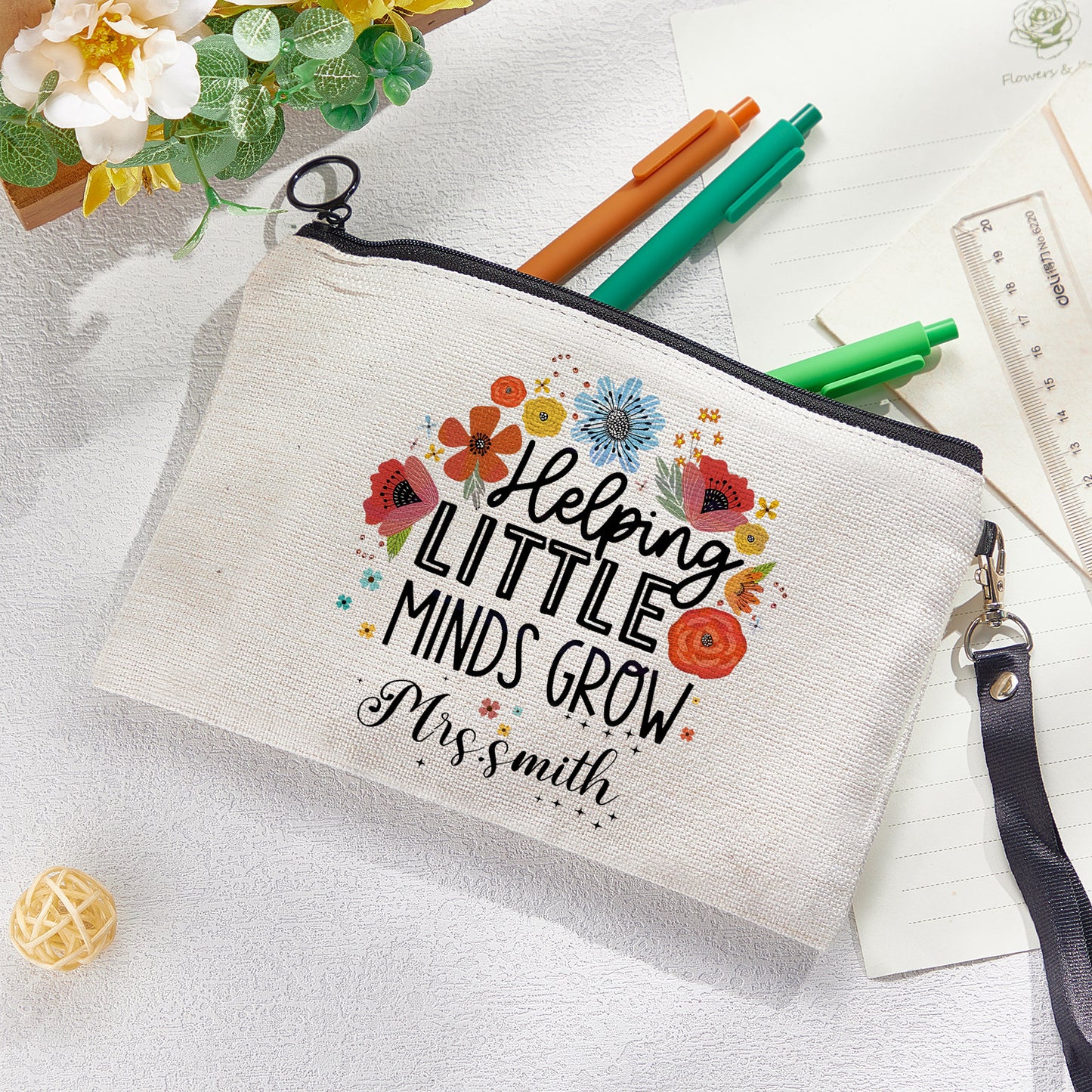 Custom canvas makeup bag with flower pencil design and name, ideal teacher gift.